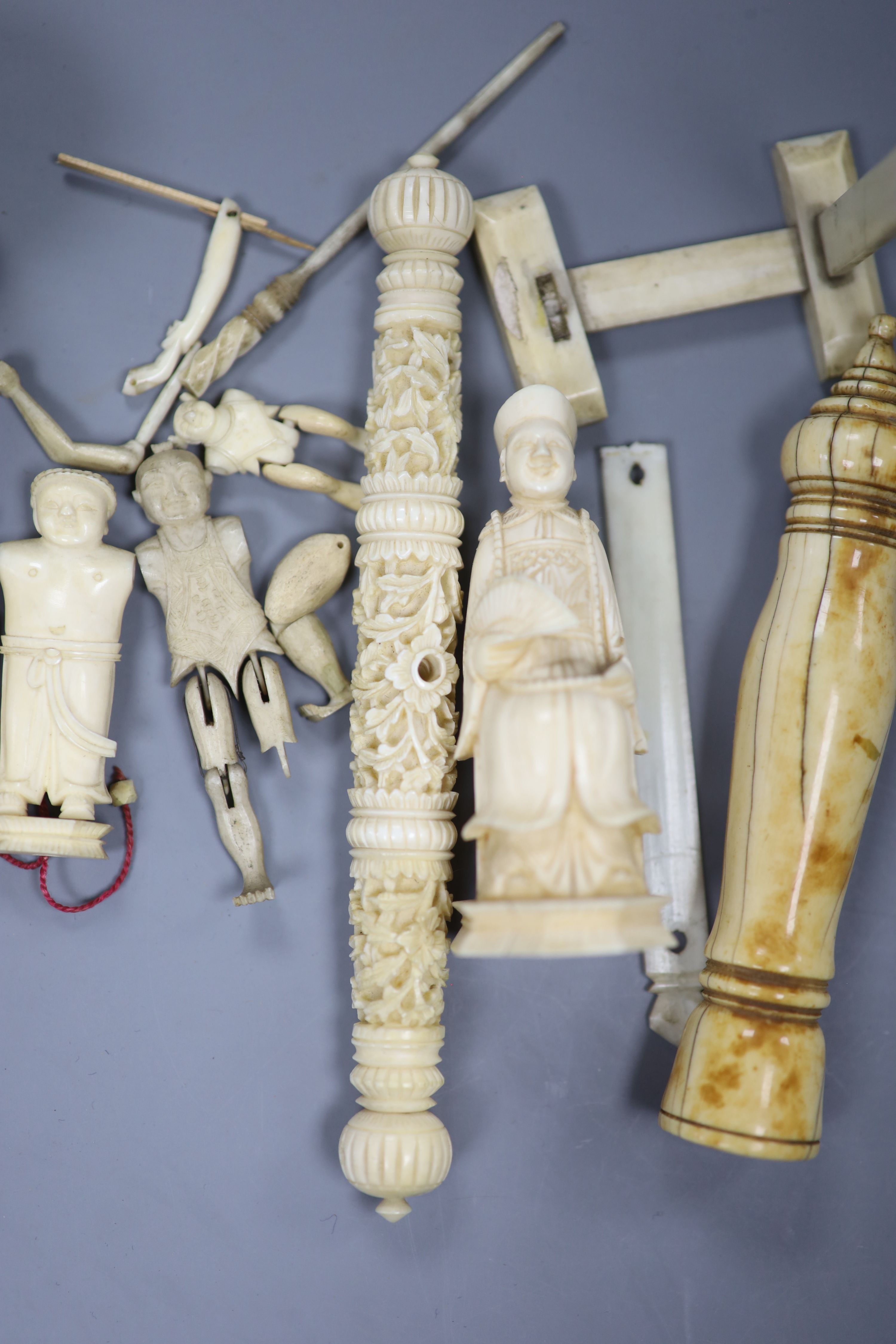 Three Chinese articulated ivory models of acrobats, two chess pieces, an ivory brush handle and needlework items